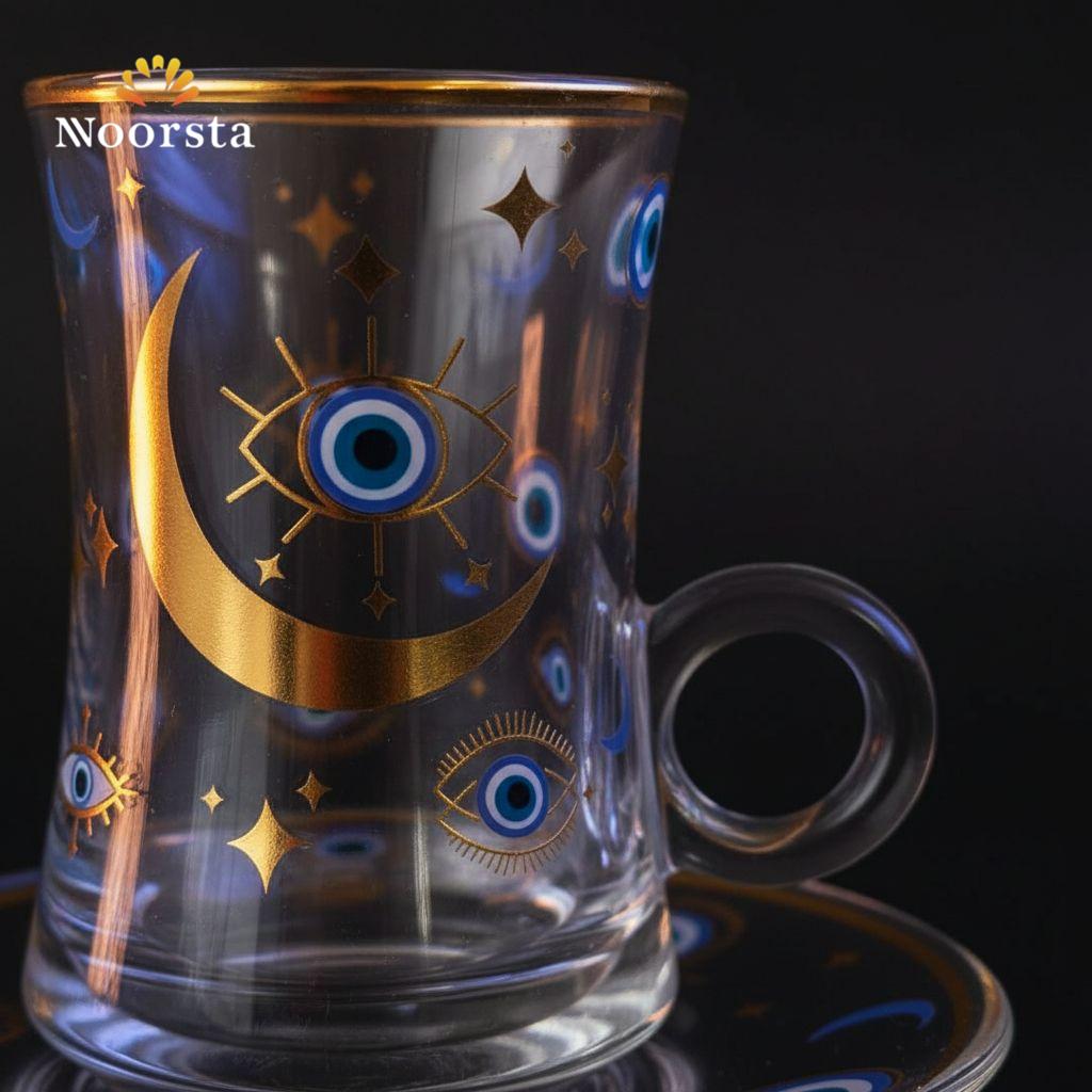 فنجان شاي قزاز بتصميم العين والهلال - Clear glass teacup and saucer with gold evil eye and moon design - Noorsta
